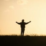 silhouette of person spreading hands